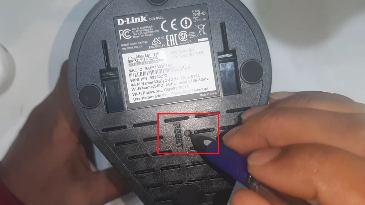Locating the Reset button at the back of the router